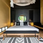 Studio Villa bedroom with circular garden window at The Mangrove by Blu Monkey