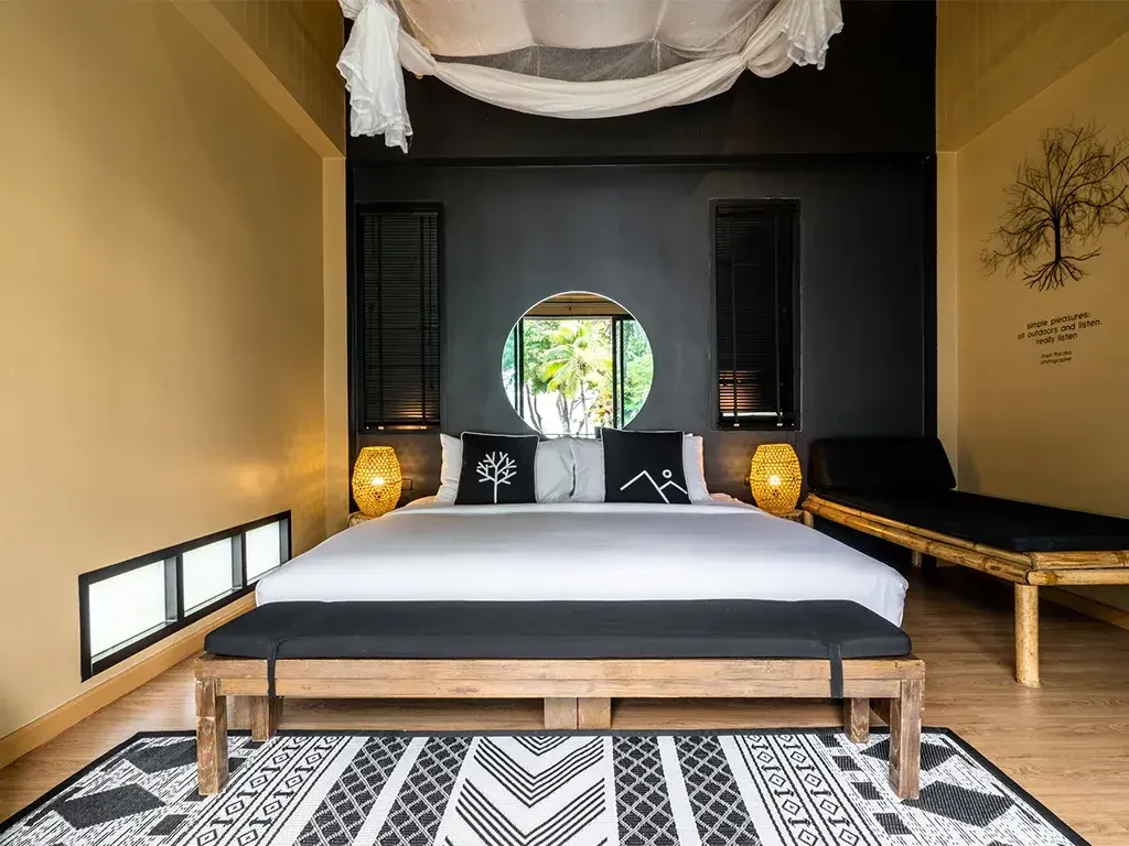 Studio Villa bedroom with circular garden window at The Mangrove by Blu Monkey