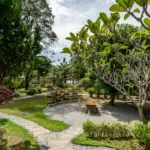 Garden seating outside the connecting family room area at The Mangrove by Blu Monkey